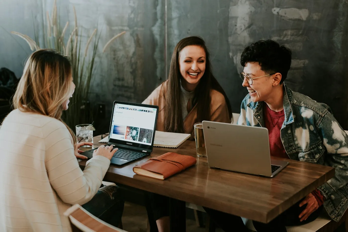People laughing at a co-working table