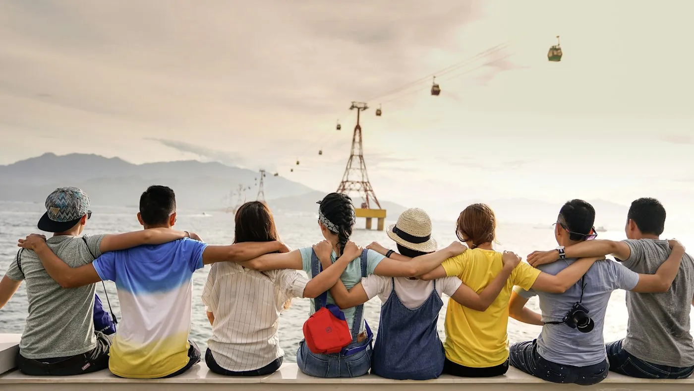 Friends sitting by the sea